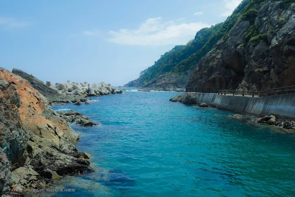 A turquoise cove and cliff path on the Kosode ria coast