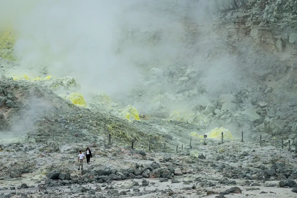 Volcanic mist drifting over the grey slopes of Mt. Iō