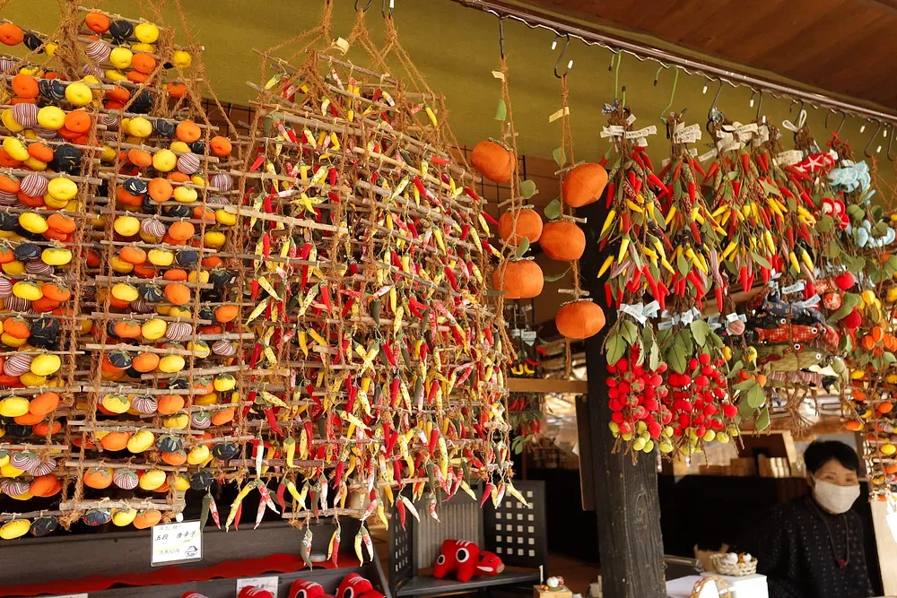 Strings of persimmons drying under the eaves of a thatched house
