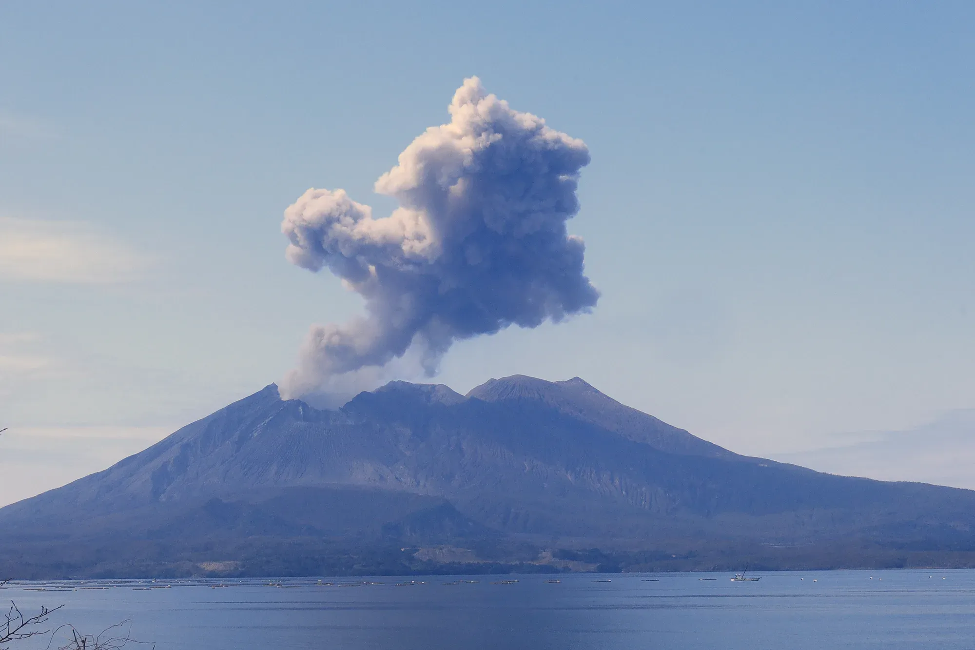 Sakurajima volcano sending up a plume of ash over Kagoshima Bay